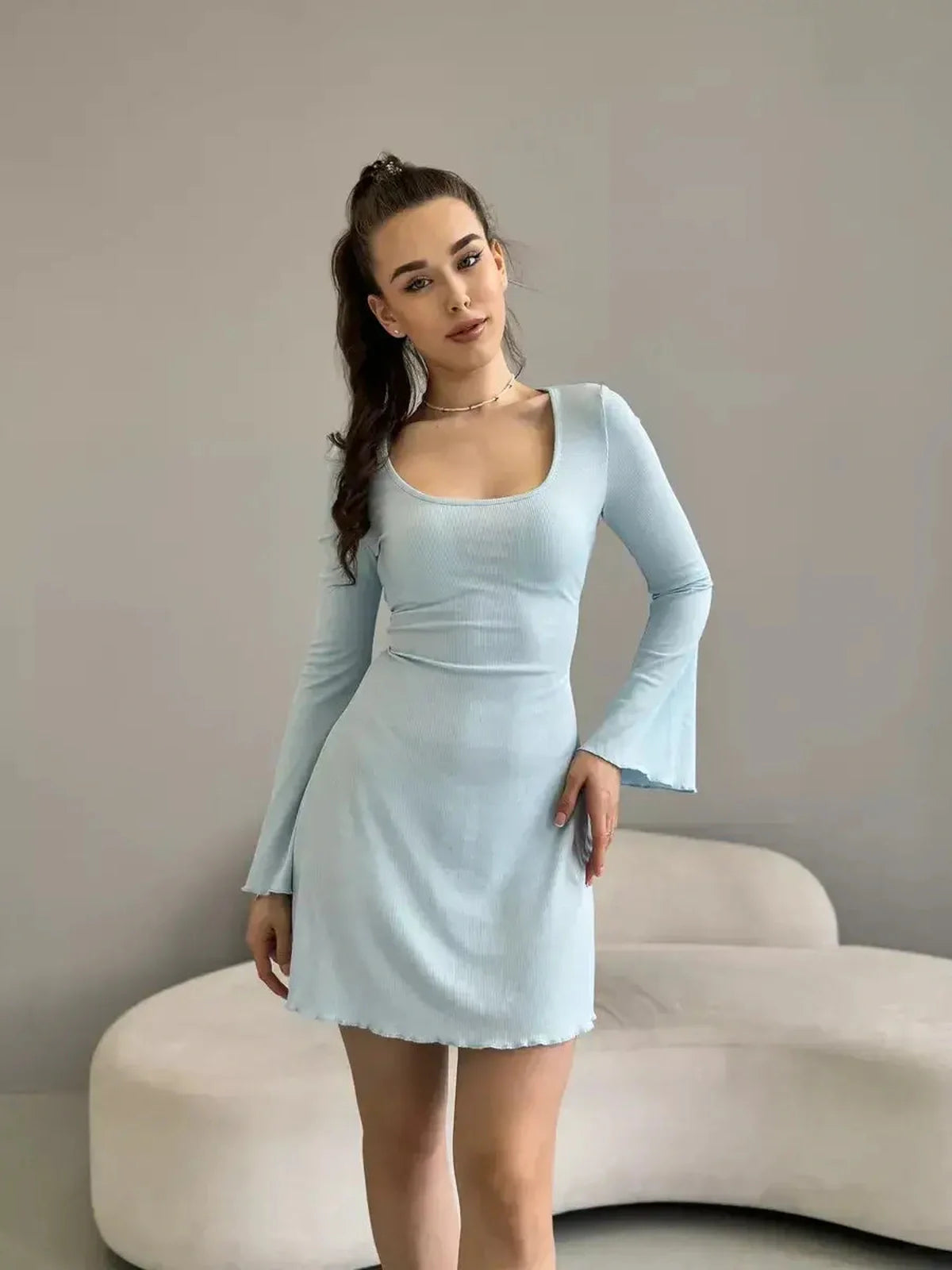 Isabella Mini Dress by Lauven in pastel blue ribbed knit, featuring long sleeves and flared hem for a modern look.