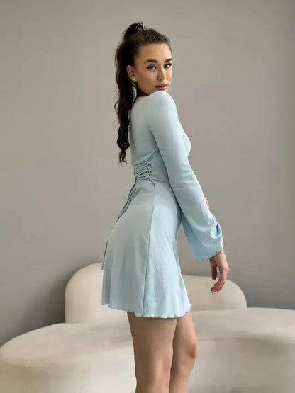 Isabella Mini Dress in soft pastel blue featuring long sleeves and a flared hem by Lauven.