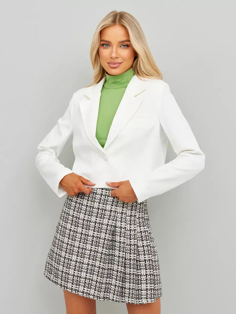 Ivory Blazer by Lauven, showcasing a cropped silhouette worn with a green turtleneck and patterned skirt.