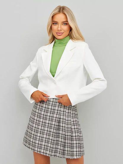 Ivory Blazer by Lauven, showcasing a cropped silhouette worn with a green turtleneck and patterned skirt.