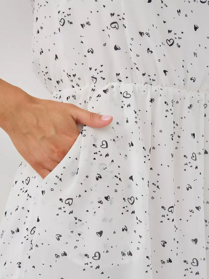 Ivory Mini Dress by Lauven featuring ruffle sleeves and a playful heart pattern with a pocket detail.