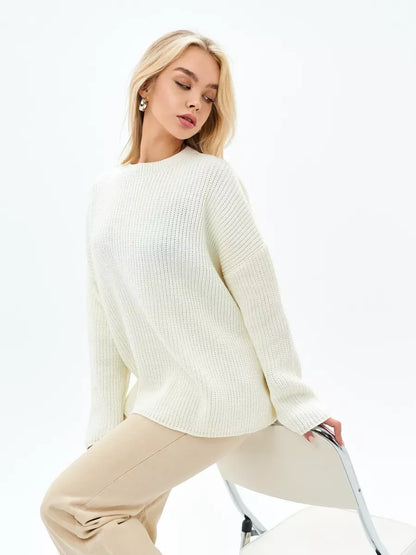 Ivory Sweater by Lauven showcasing elegant oversized knit in soft cream worn stylishly with beige trousers.