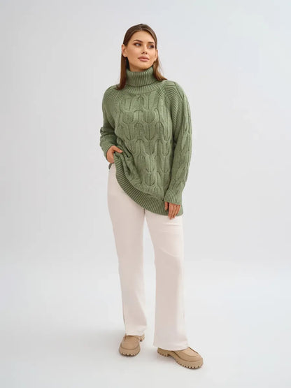 Women wearing the Ivy Sweater by Lauven, an oversized cable knit high neck piece in green color.