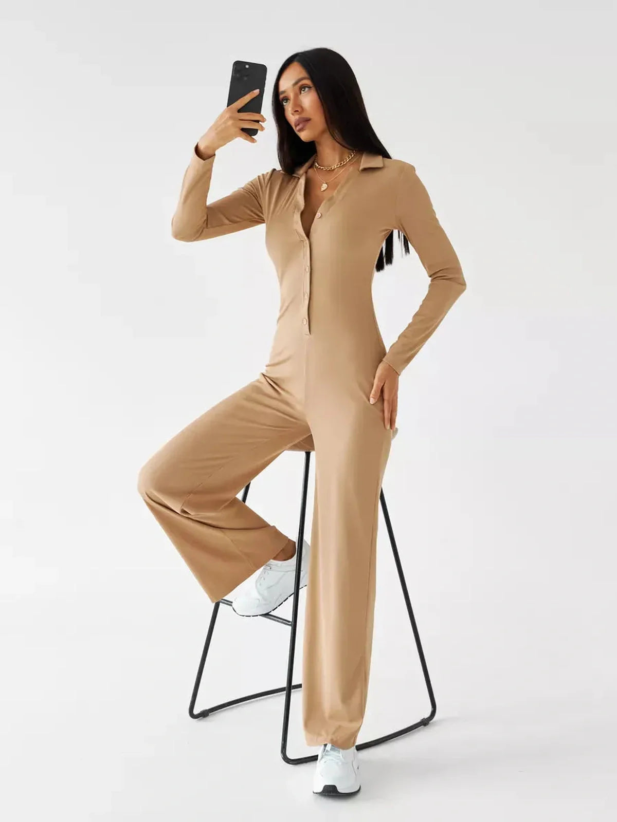 Jersey Jumpsuit in sand ribbed knit, featuring a button-front, wide-leg silhouette, and long fitted sleeves.