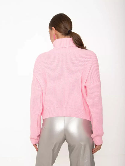 Back view of a woman wearing the Blossom Pullover by Lauven, an oversized light pink knit sweater with high neck.