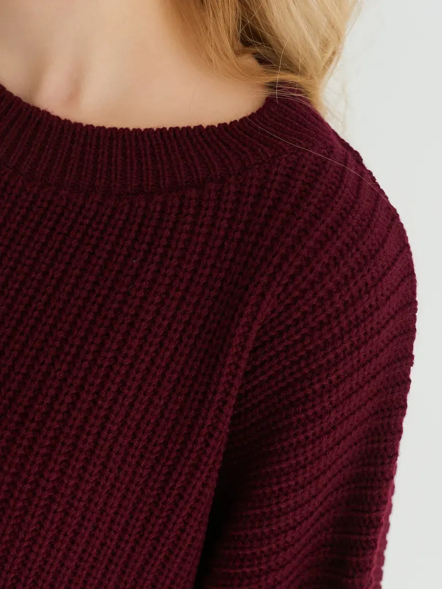 Close-up detail of the Bordeaux Sweater by Lauven in deep burgundy knit, showcasing its ribbed texture.