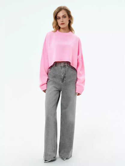 Cropped oversized knit in soft pink, the Candy Sweater by Lauven for playful, feminine style.