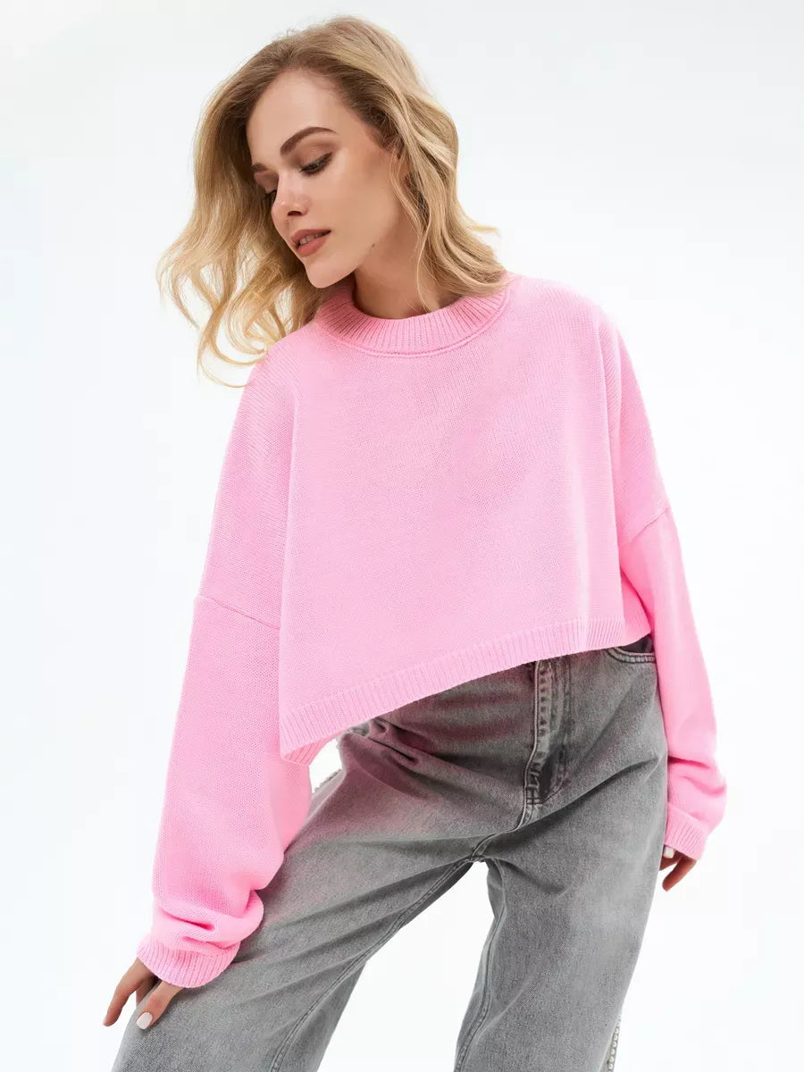 Model wearing the Candy Sweater by Lauven, a cropped oversized knit in soft pink.