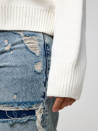 Detail of Celeste Pullover by Lauven, showcasing the soft ivory texture and cropped sleeve design.