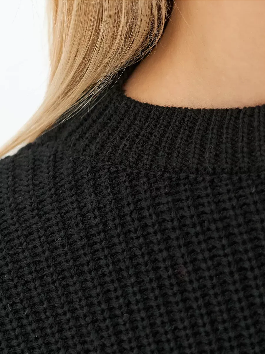 Close-up of the soft texture of the Lauven Eclipse Sweater in classic black, showcasing its cozy knit design.
