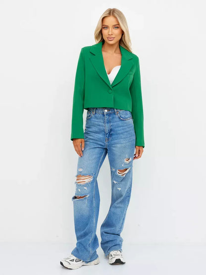 Emerald Blazer by Lauven, cropped tailored elegance in vibrant green paired with blue jeans for a stylish look.