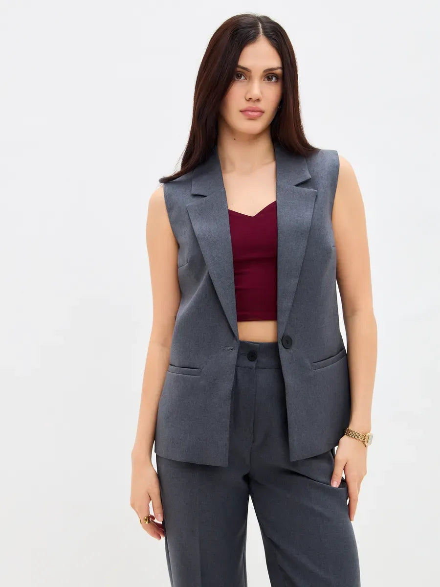 Model wearing Lauven Graphite Suit Set featuring a sleeveless vest and high-waist pants.