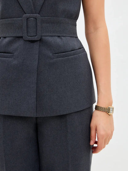 Graphite Suit Set by Lauven featuring a sleeveless vest with a belt and high-waist trousers.
