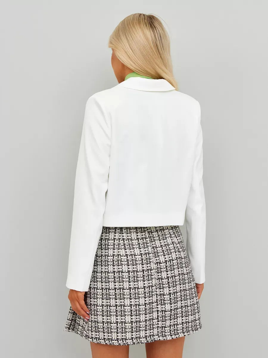 Back view of a woman wearing a Lauven Ivory Blazer styled with a tweed skirt, showcasing cropped elegance.