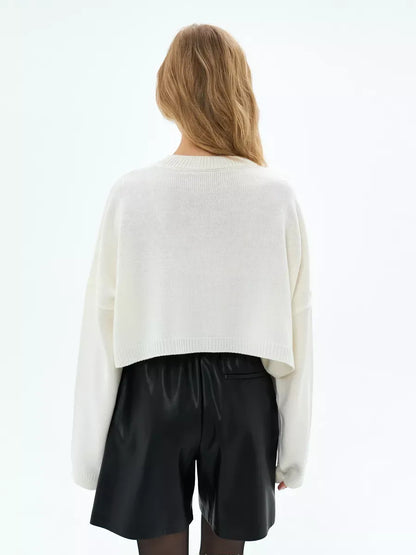Ivory Sweater by Lauven, back view of a cropped oversized knit in pure white with stylish black shorts.