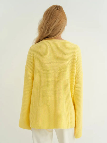 Back view of the Lemonade Sweater by Lauven in soft lemon yellow, showcasing its oversized knit design.