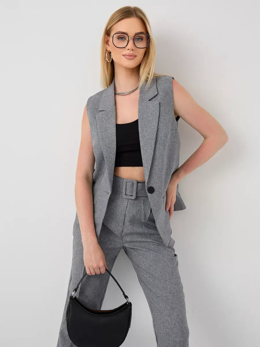 Model showcasing the Luna Suit Set by Lauven, featuring a sleeveless gray vest and high-waist pants.
