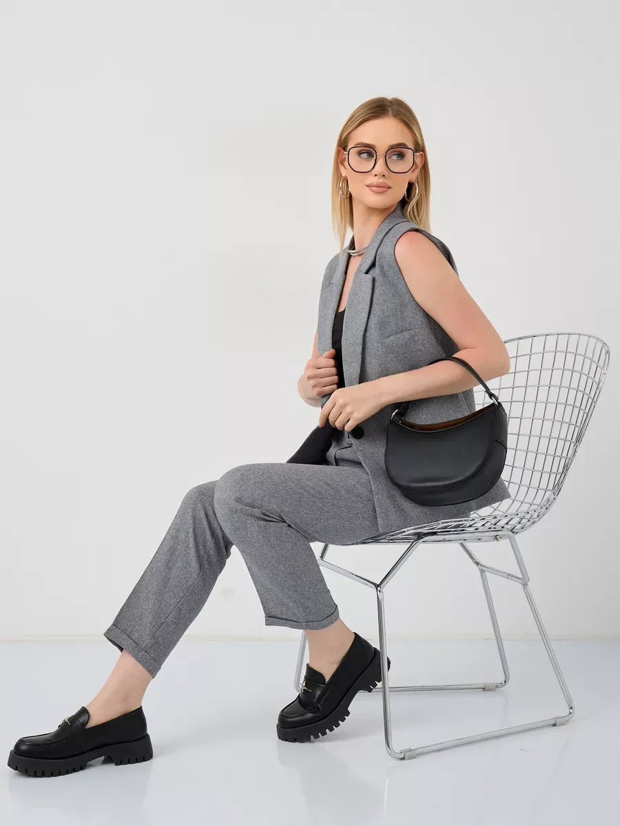 Luna Suit Set by Lauven featuring a sleeveless gray vest and high-waist pants styled with chic accessories.