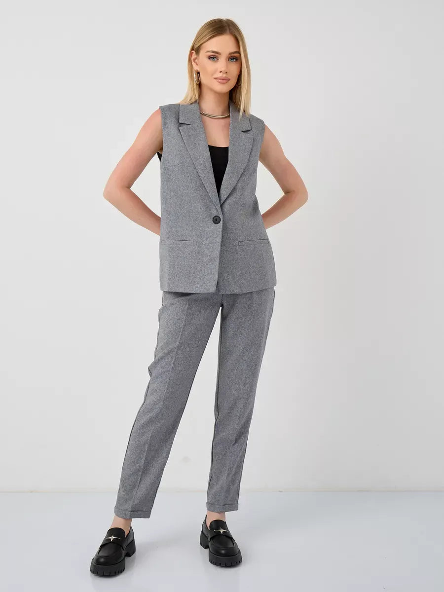 Model wearing the Luna Suit Set by Lauven, featuring a sleeveless gray vest and high-waist pants in a modern style.