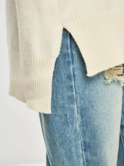 Luna Sweater by Lauven featuring an oversized cashmere blend design in ivory, paired with denim for a chic look.