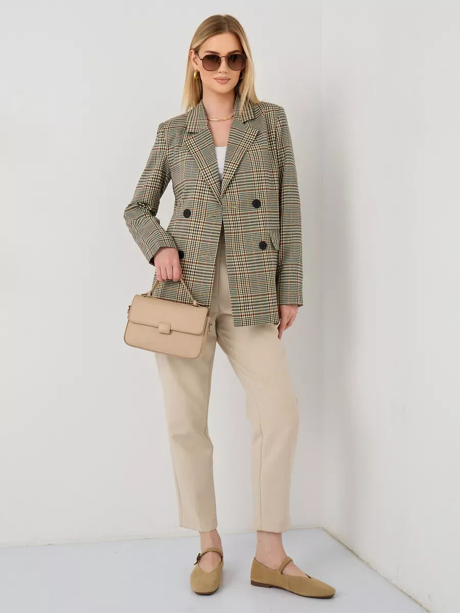 Elegant woman wearing a Maple Blazer by Lauven, styled with sunglasses and a beige bag for a trendy look.