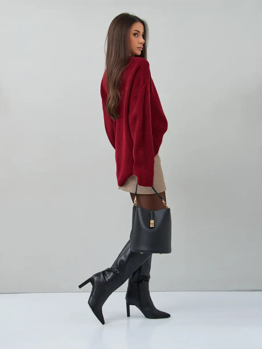 Model wearing Maribel Sweater by Lauven, oversized burgundy knit with stylish knee-high boots.