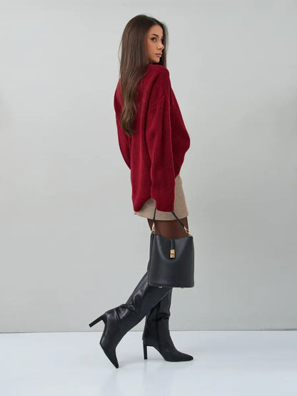 Model wearing Maribel Sweater by Lauven, oversized burgundy knit with stylish knee-high boots.