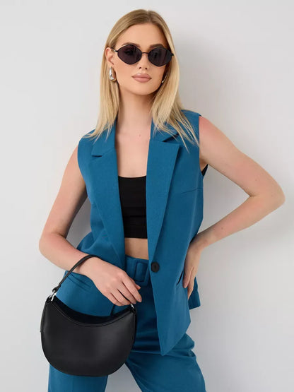 Lauven Marine Suit Set featuring a sleeveless teal vest and high-waist pants, styled with a black handbag and sunglasses.