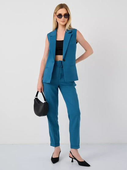 Model wearing Marine Suit Set by Lauven, featuring sleeveless teal vest and high-waist pants, perfect for stylish occasions.