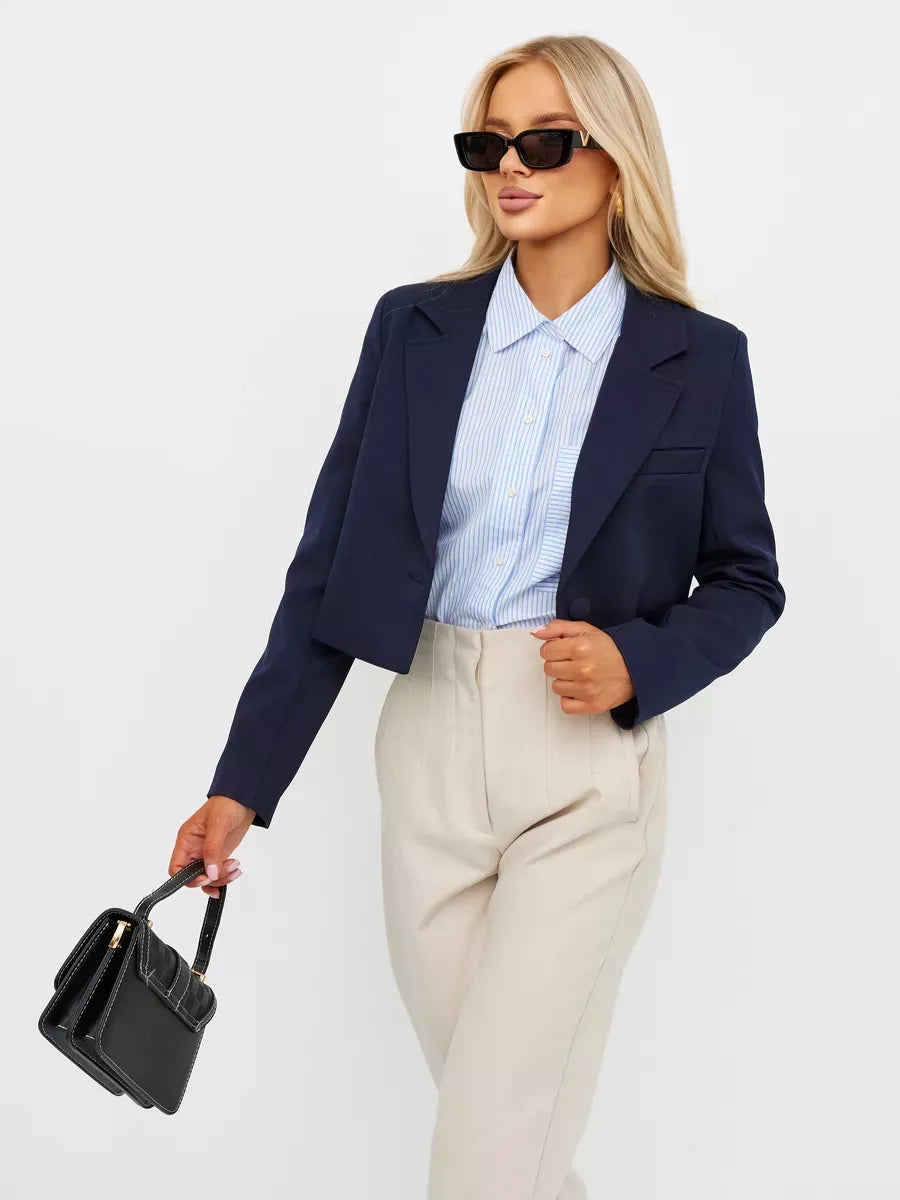 Navy Blazer by Lauven showcasing cropped tailored elegance in a chic outfit featuring a blue shirt and bag.