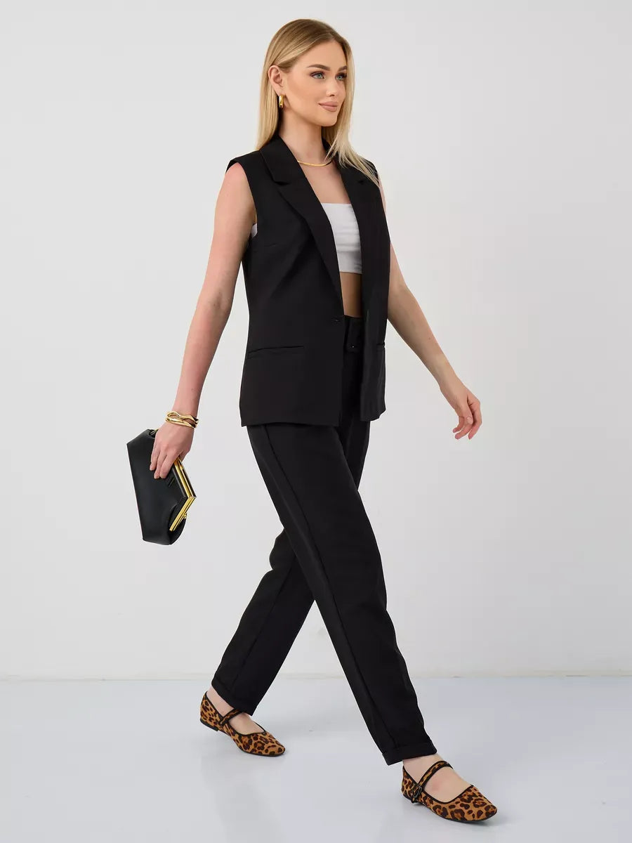 Noir Suit Set by Lauven featuring a sleeveless black vest and high-waist pants, stylishly worn by a model.