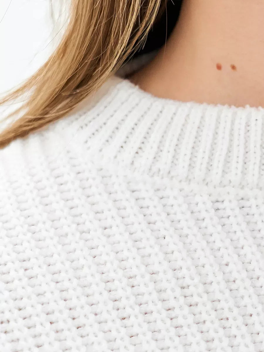Nova Sweater detail featuring rib-knit texture, crafted by Lauven, showcasing cozy elegance in white.