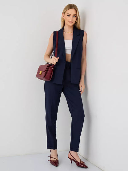 Orion Suit Set by Lauven featuring a sleeveless navy vest and high-waist trousers, perfect for modern women's fashion.