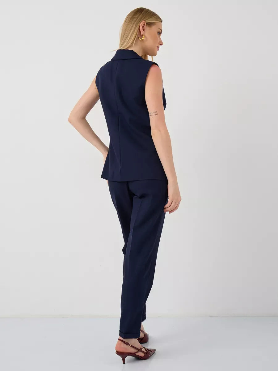Orion Suit Set by Lauven featuring a sleeveless navy vest and high-waist pants, perfect for modern women.