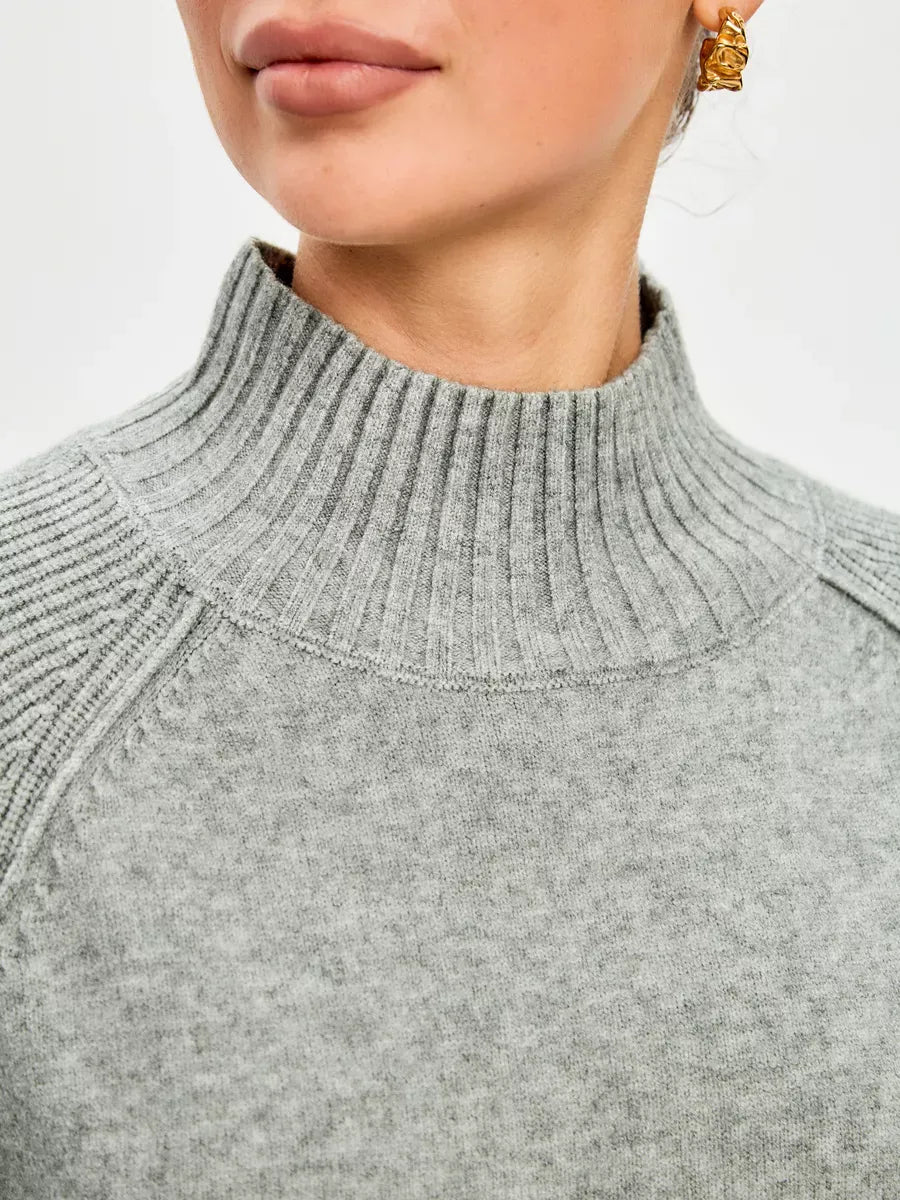 Close-up of the Sterling Sweater by Lauven, showcasing the soft grey cashmere blend and high ribbed neckline.