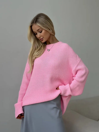 Model wearing the Poppy Sweater by Lauven, an oversized light pink knit sweater with a relaxed fit and crew neck.