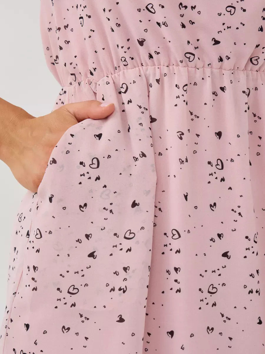 Rose Mini Dress by Lauven featuring a playful pink fabric with heart patterns and a convenient pocket detail.