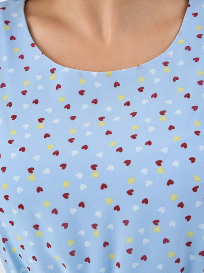 Sky Mini Dress by Lauven – Light blue fabric with colorful heart pattern, showcasing ruffle sleeve details.