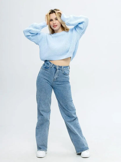 Model wearing Skylar Pullover, cropped knit in sky blue, paired with light wash jeans by Lauven.