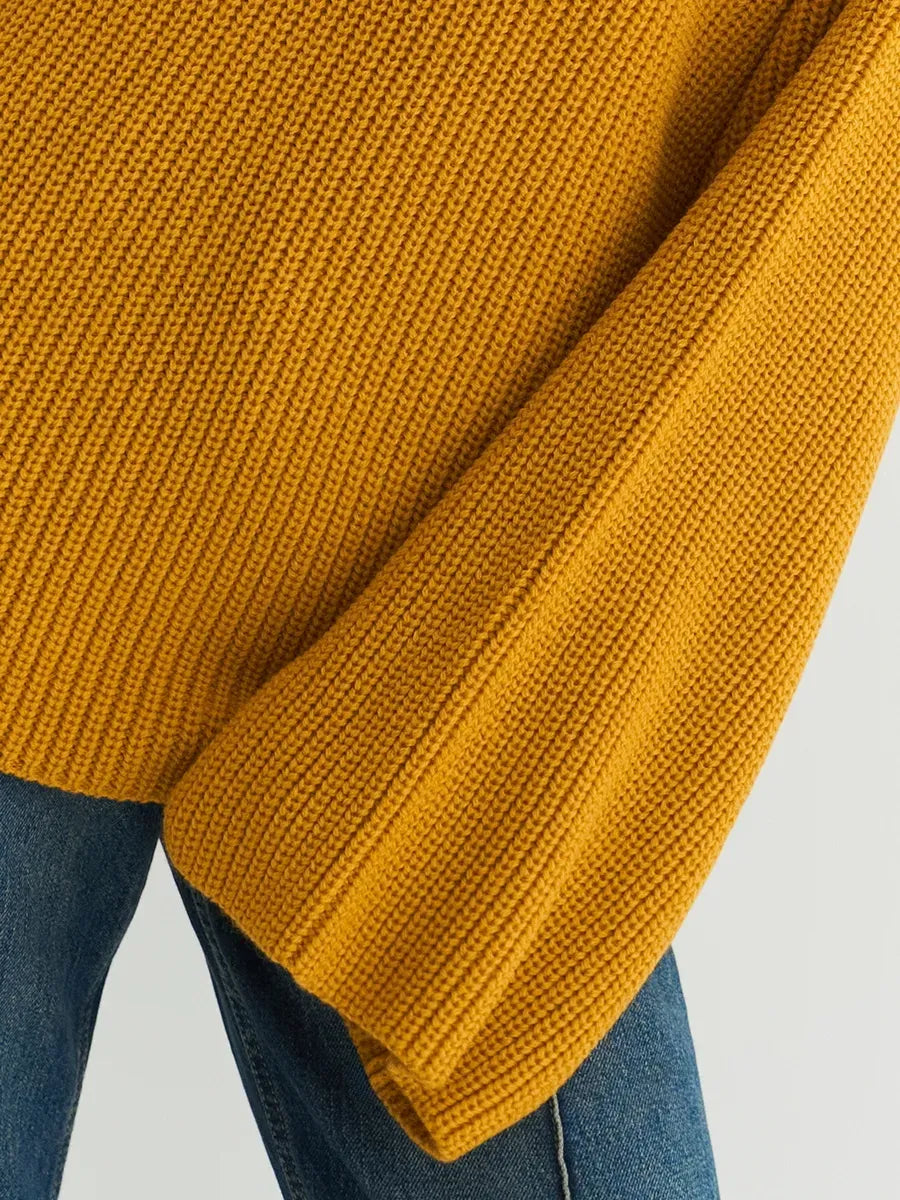 Solara Sweater by Lauven in mustard yellow, showcasing the oversized knit and ribbed texture for a stylish look.