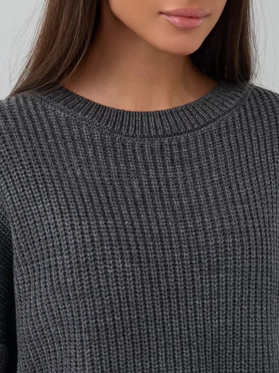 Close-up of the Vera Sweater by Lauven, showcasing the oversized dark gray knit and crew neck design.