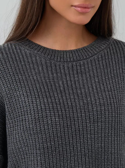 Close-up of the Vera Sweater by Lauven, showcasing the oversized dark gray knit and crew neck design.