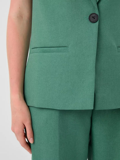 Close-up of Lauven Verde Suit Set featuring a tailored green vest and high-waist pants.