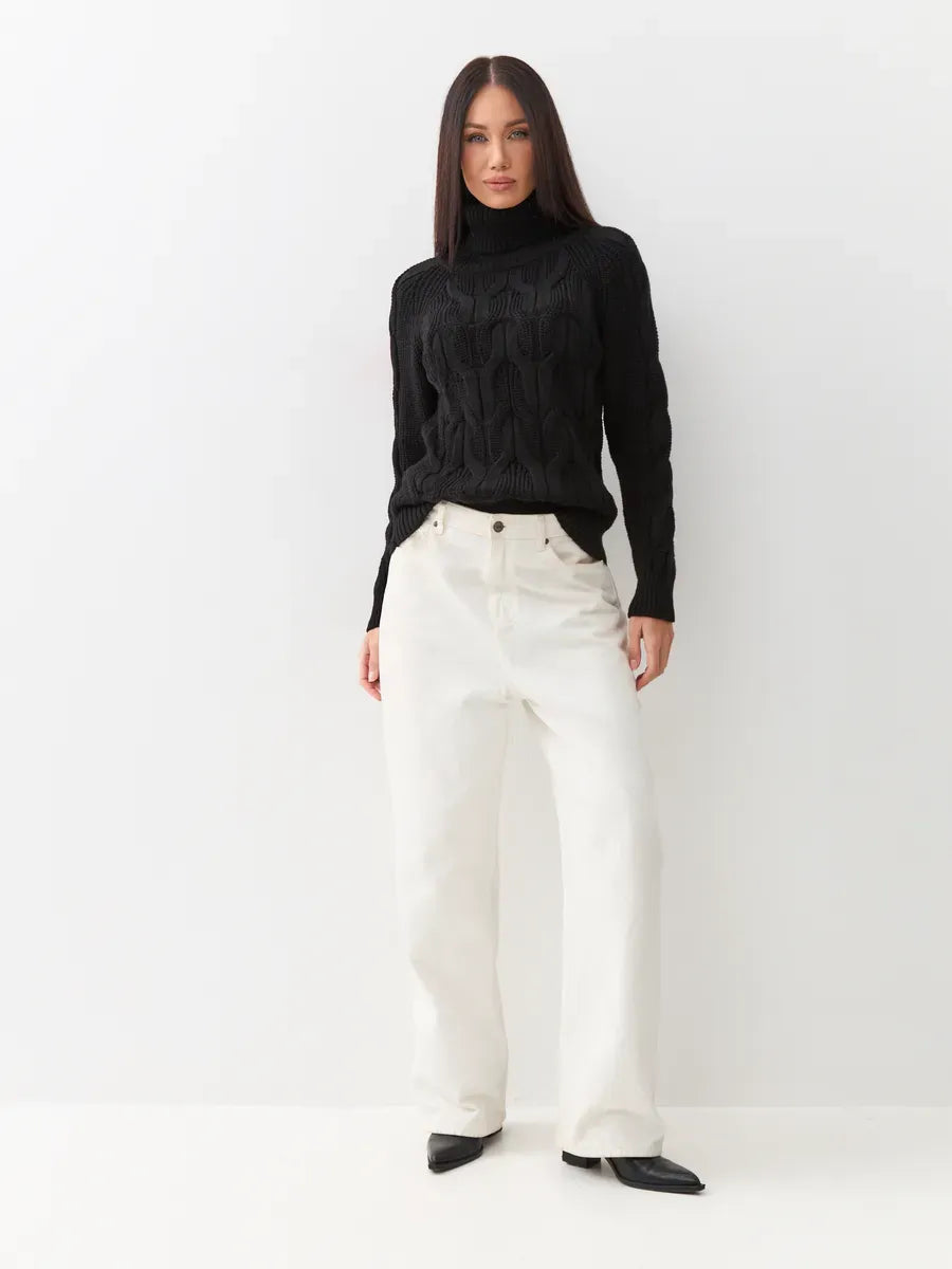 Noir Knitwear by Lauven: Women’s wool-blend turtleneck sweater styled with casual white pants.