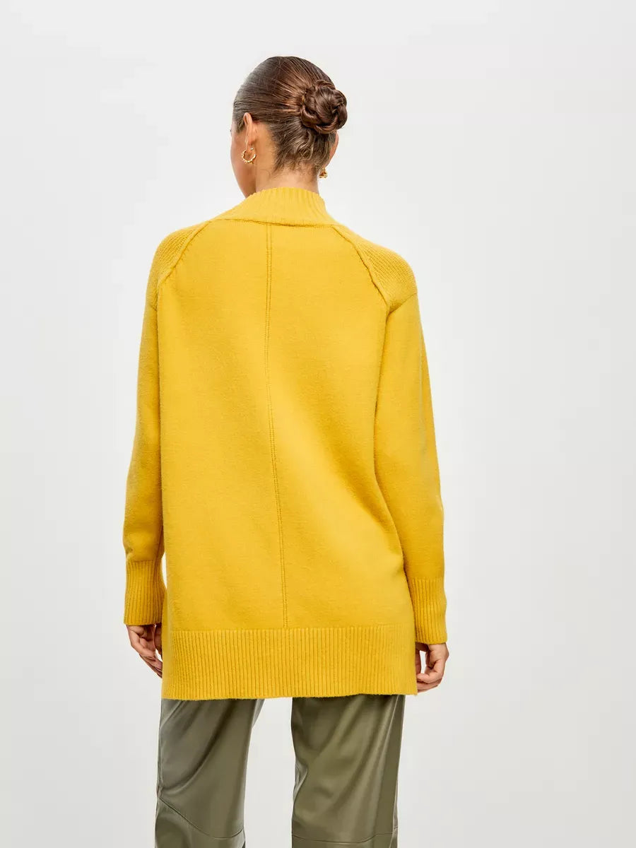 Back view of a woman wearing a Marigold Sweater from Lauven, showcasing its oversized design and cozy fabric.