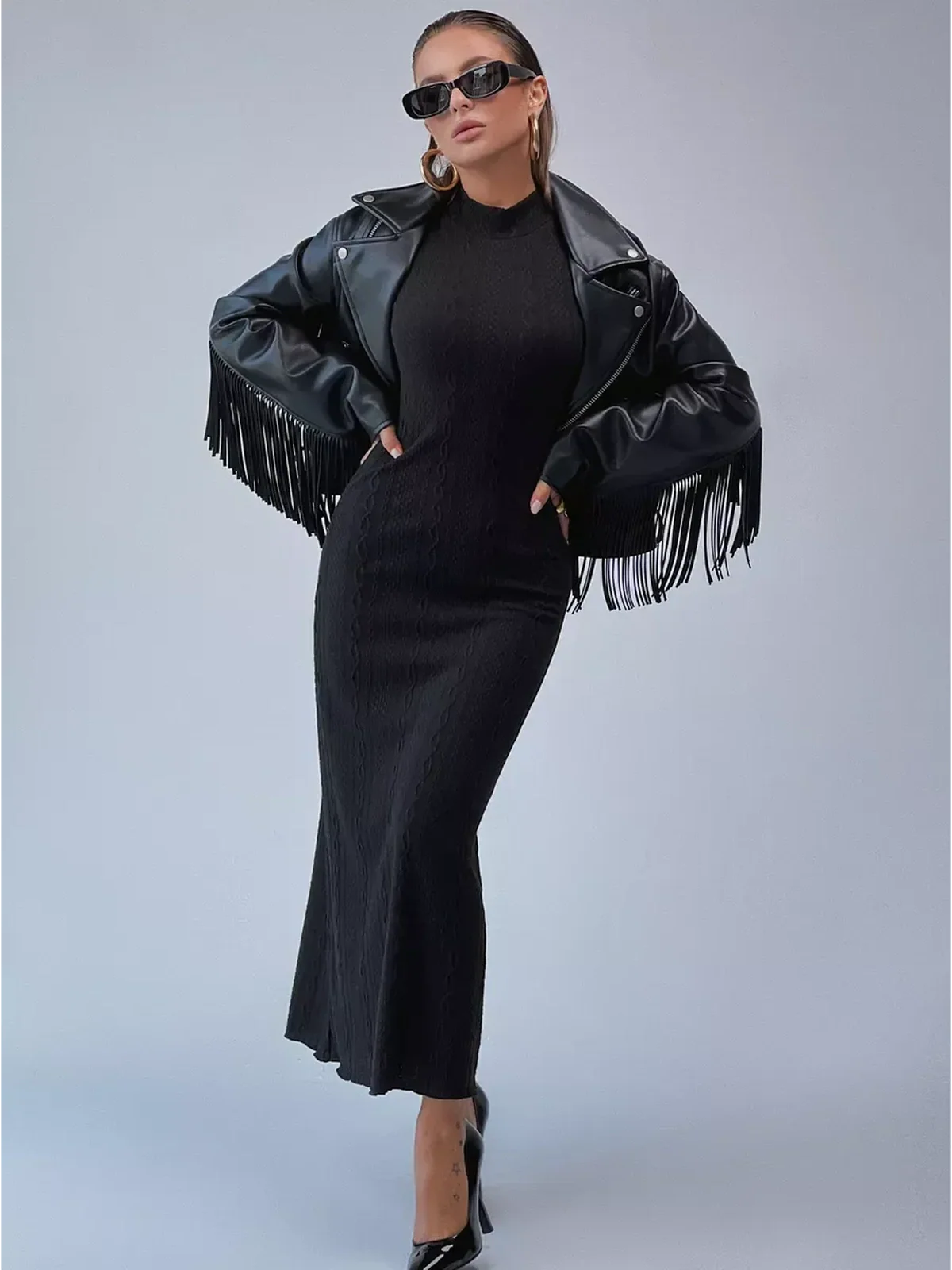 Leah Maxi Dress by Lauven, black knit bodycon gown with a high neck and floor-grazing hem, styled with a leather jacket.