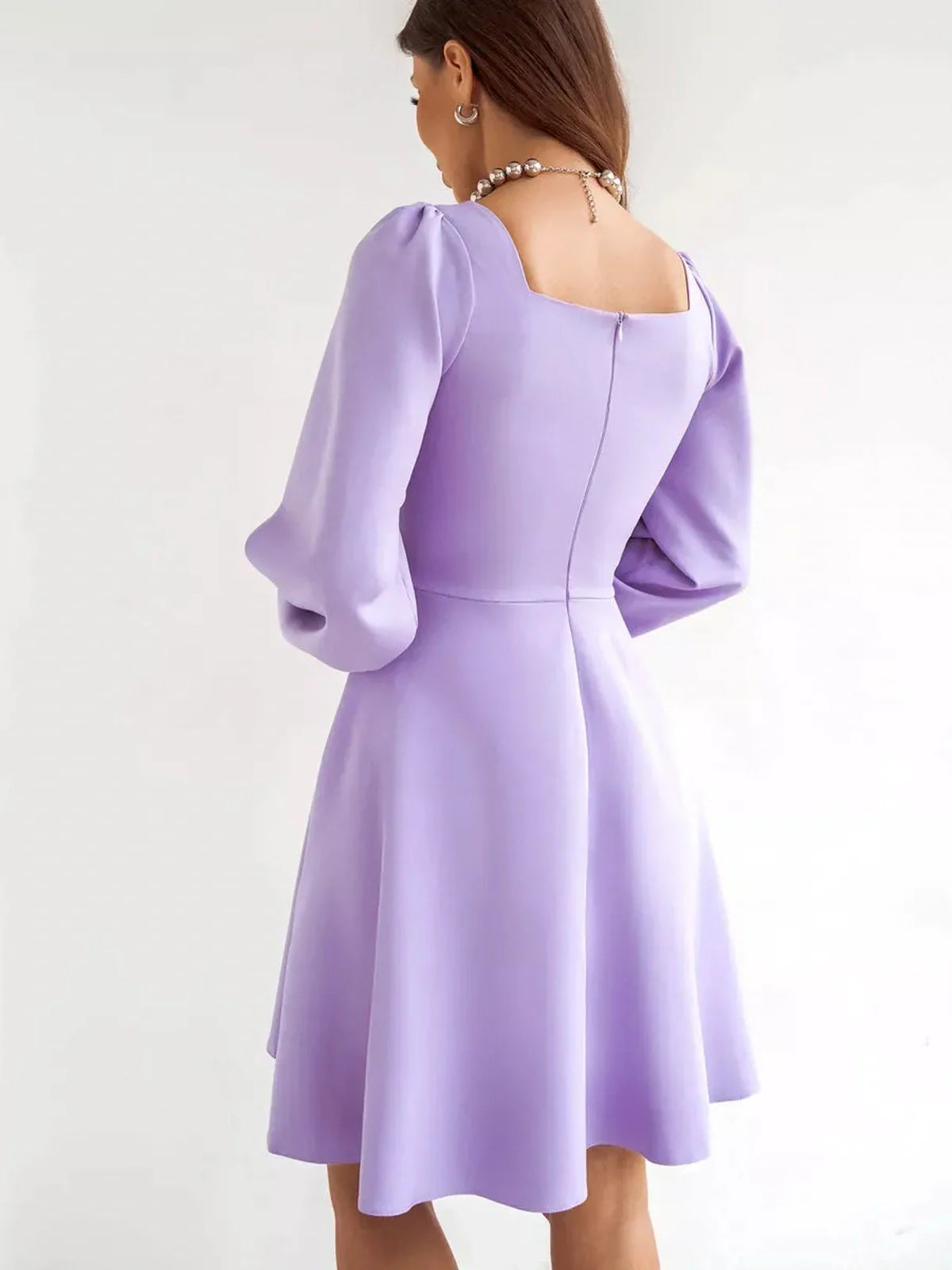 Lilac Mini Dress by Lauven showcasing a sophisticated back view with a flared skirt and long sleeves.