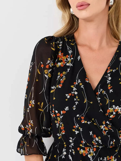 Lotus Mini Dress by Lauven featuring a black floral print, deep V-neckline, and 3/4 puff sleeves.