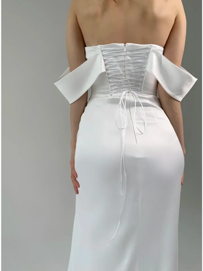 Lyra Occasion Dress by Lauven, back view showcasing off-shoulder design and draped satin detail.