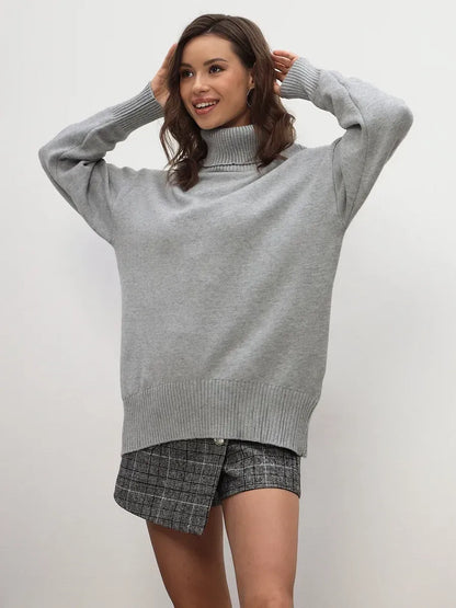 Woman wearing the Lyra Sweater from Lauven, a light grey turtleneck knitwear essential.